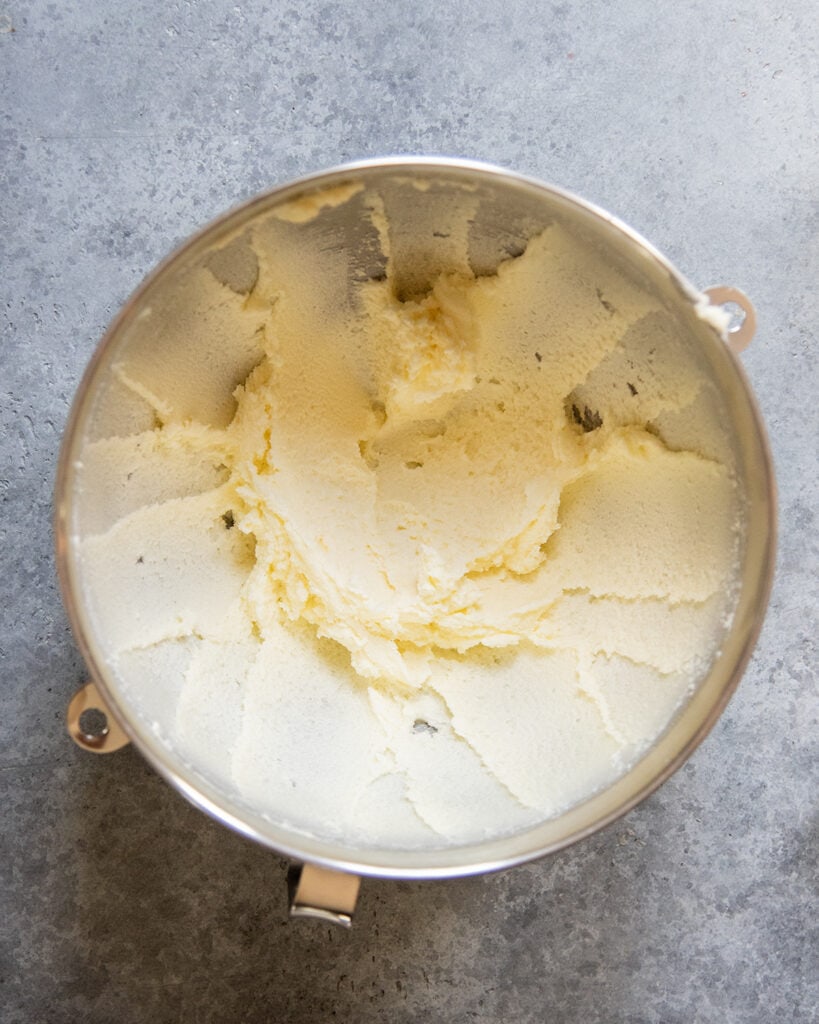 A mixing bowl with creamed butter and sugar in it. 