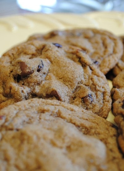 Angled view of double chocolate cherry cookies on a white plate.