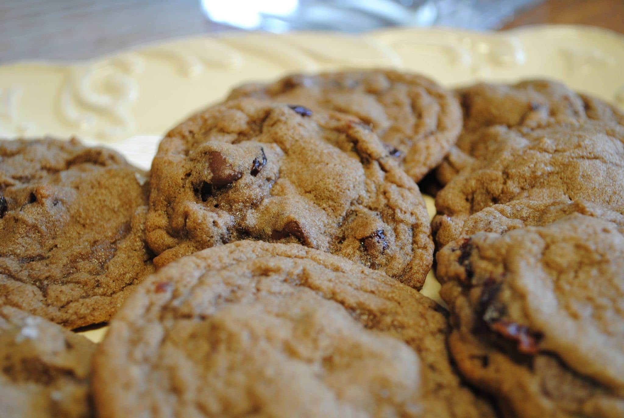 Angled view of double chocolate cherry cookies on a white plate.