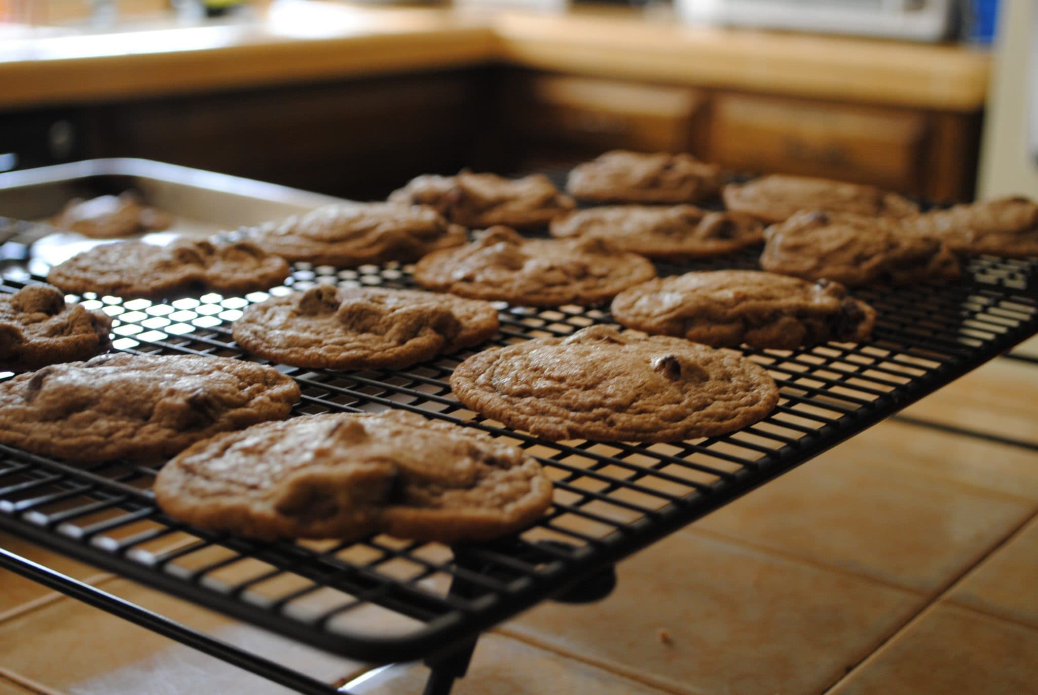 Angled view of double chocolate cherry cookies on a cooling rack.