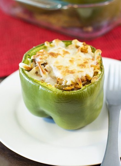 Angled view of italian stuffed peppers on a white plate.