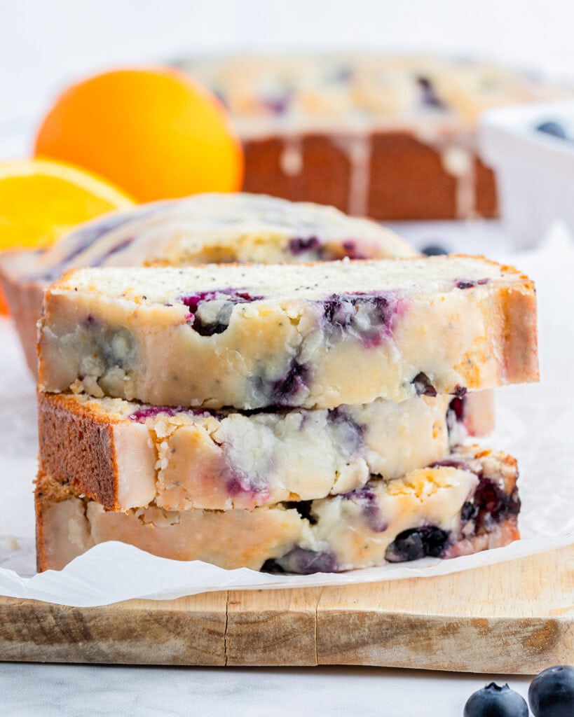 A stack of three slices of blueberry poppy seed bread in a stack.