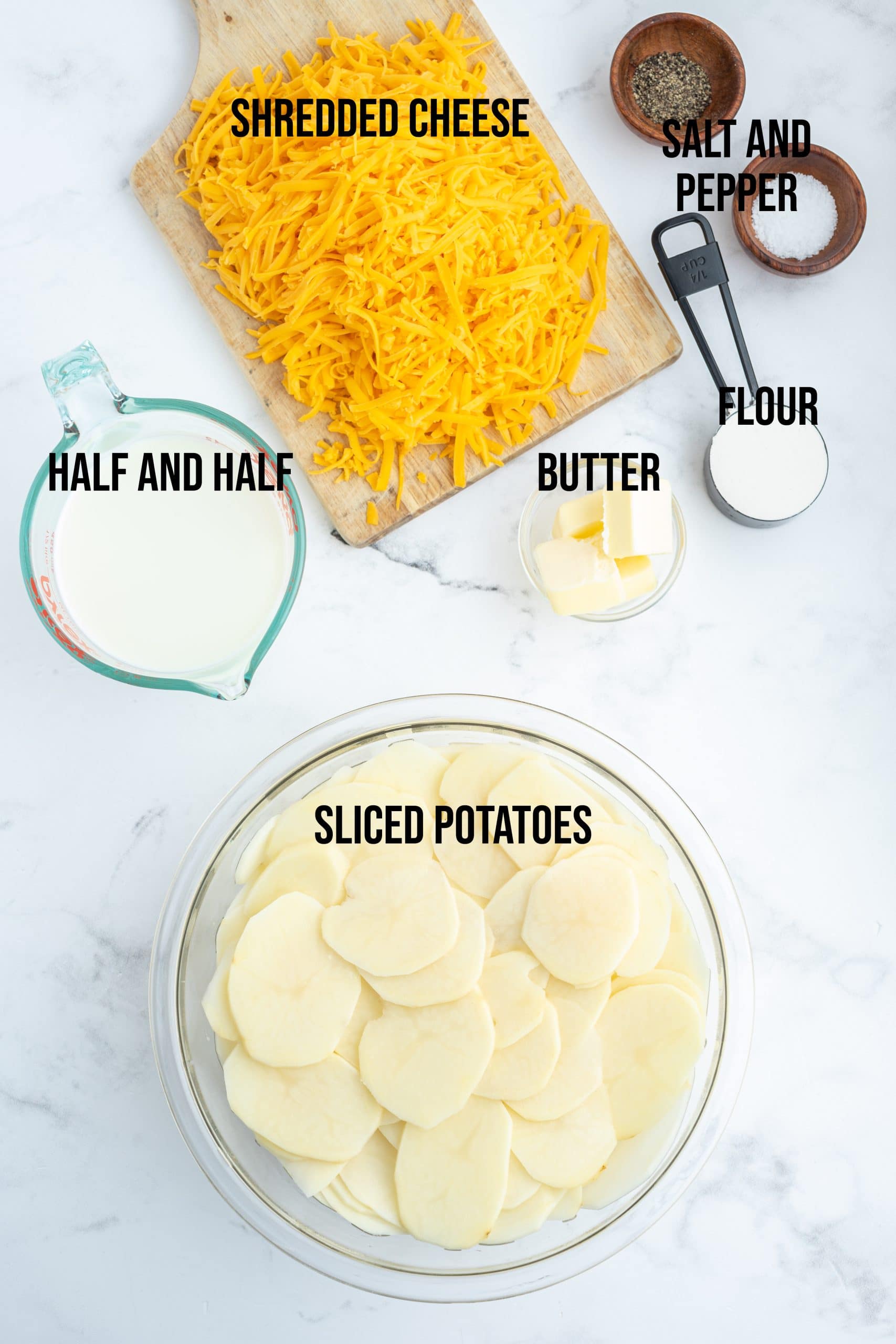 An overhead photo of the ingredients needed to make cheesy scalloped potatoes. 