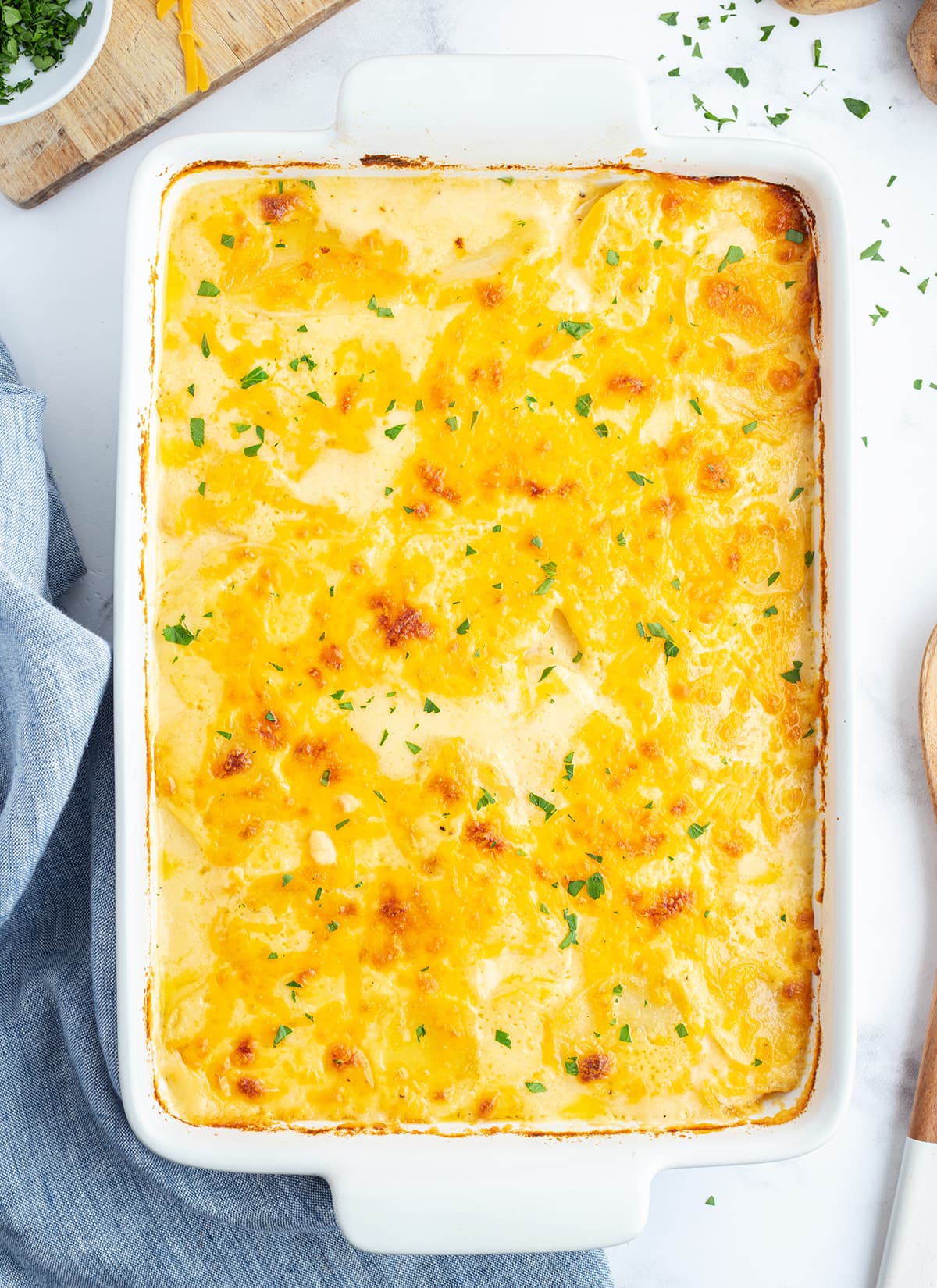 An overhead photo of a pan of cheesy scalloped potatoes.