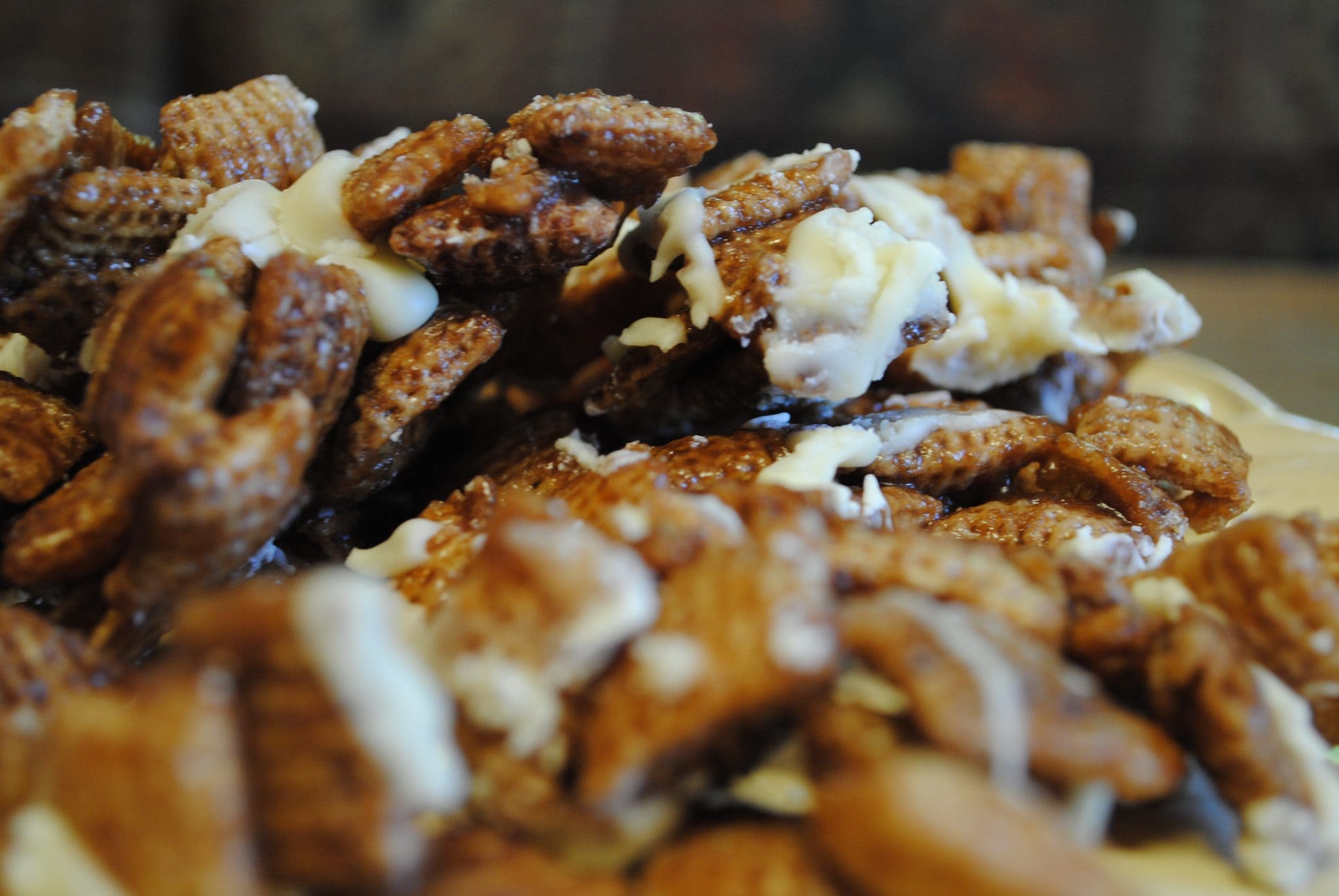 DSC_0703 Close up view of chocolate caramel chex mix on a white plate.