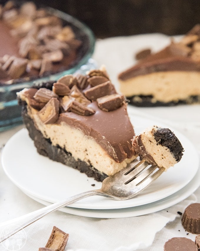 A piece of peanut butter pie topped with chocolate ganache.
