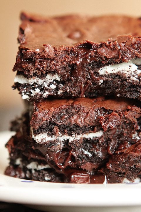 cookies-and-cream-oreo-fudge-brownies-5 Cookies and cream oreo fudge brownies stacked up on top of each other.