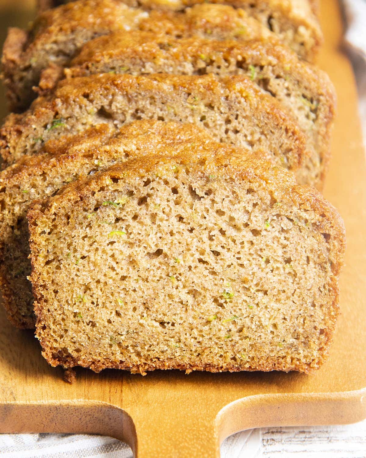 Slices of zucchini bread leaning on one another.