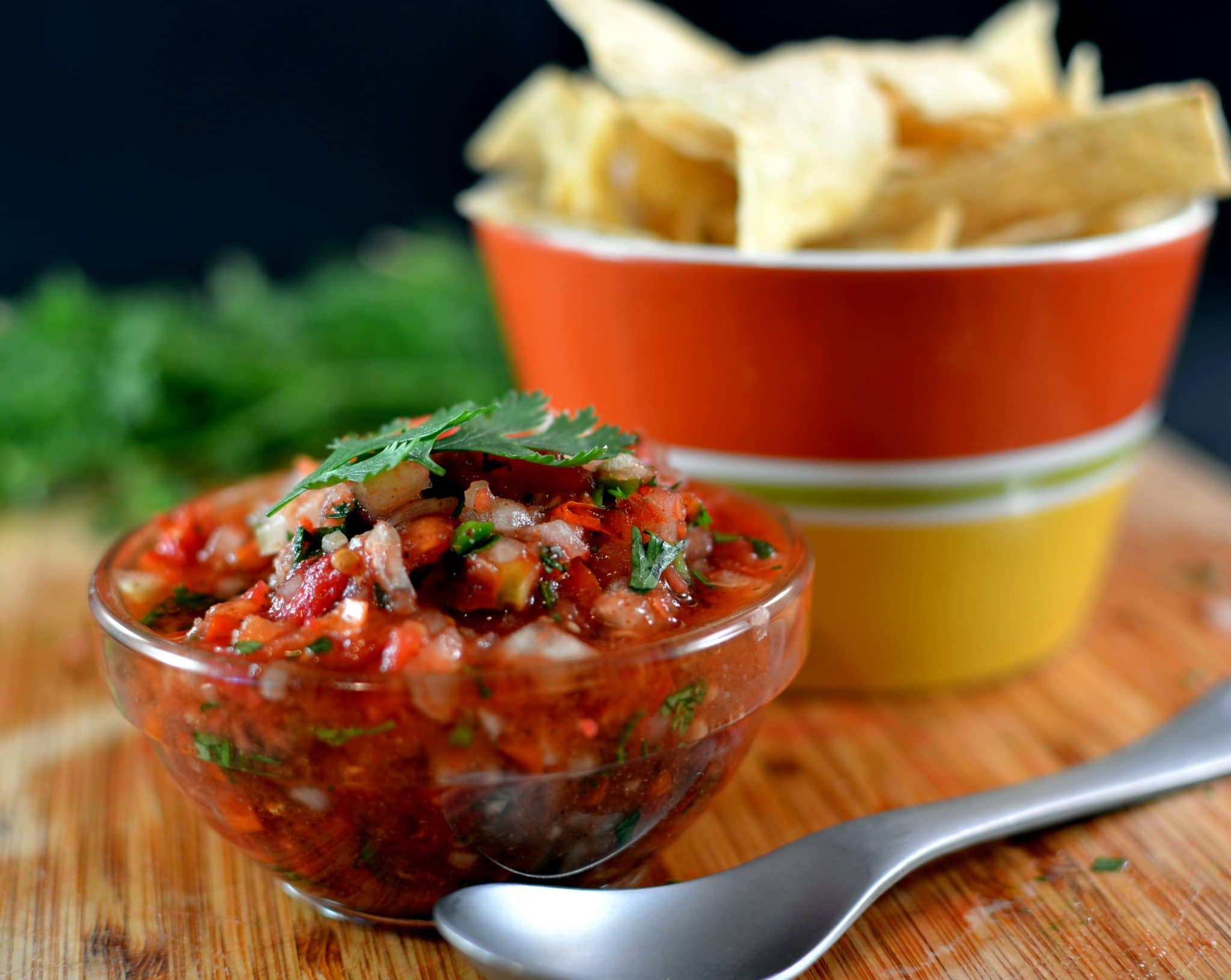 Front view of fresh salsa in a white glass bowl.
