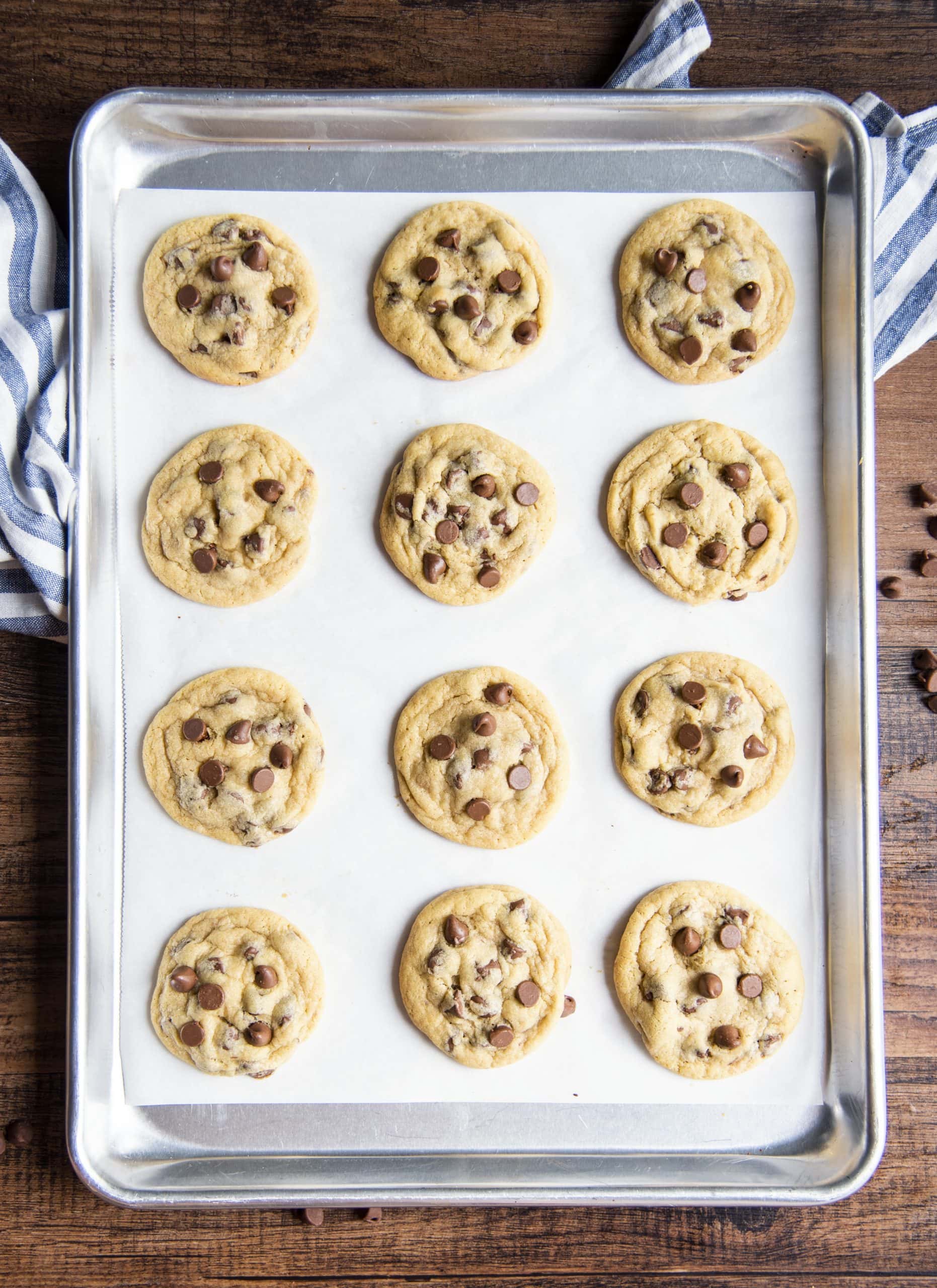 A pan of chocolate chip pudding cookies on parchment paper.