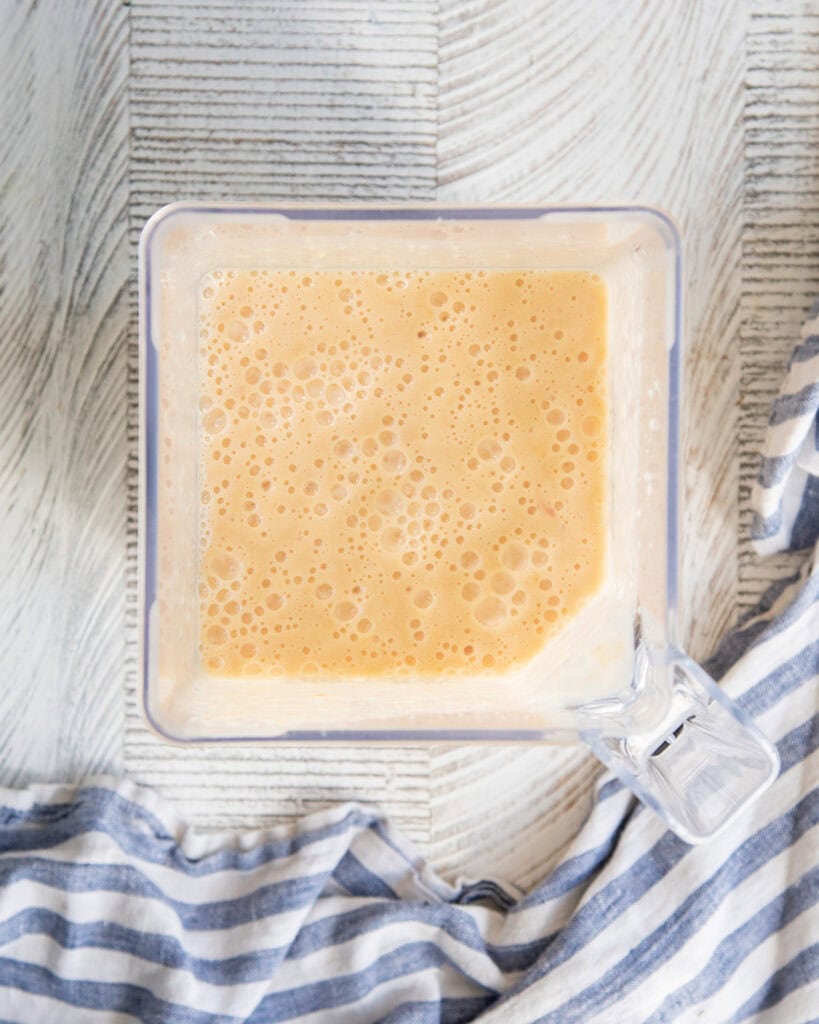 Blended peach puree in a blender.