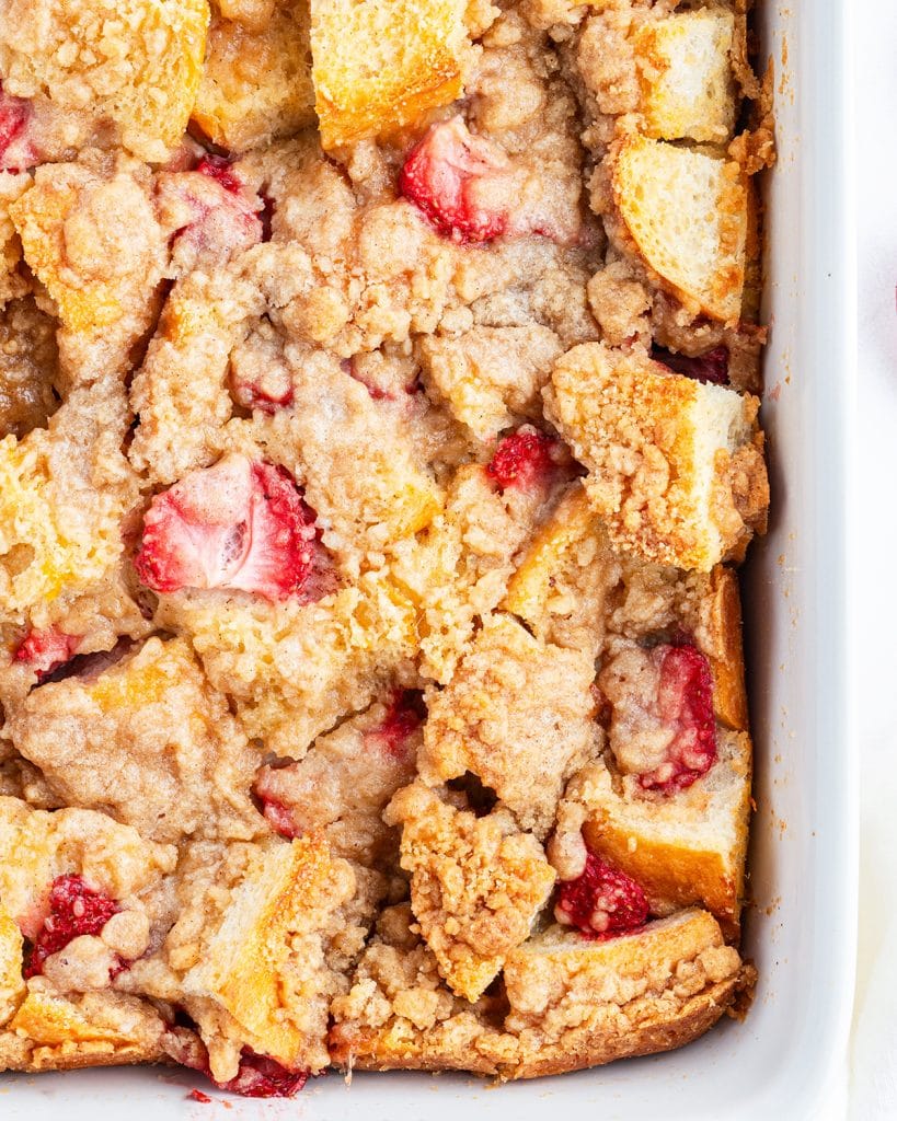 An overhead photo of overnight strawberry french toast topped with a streusel crumb.
