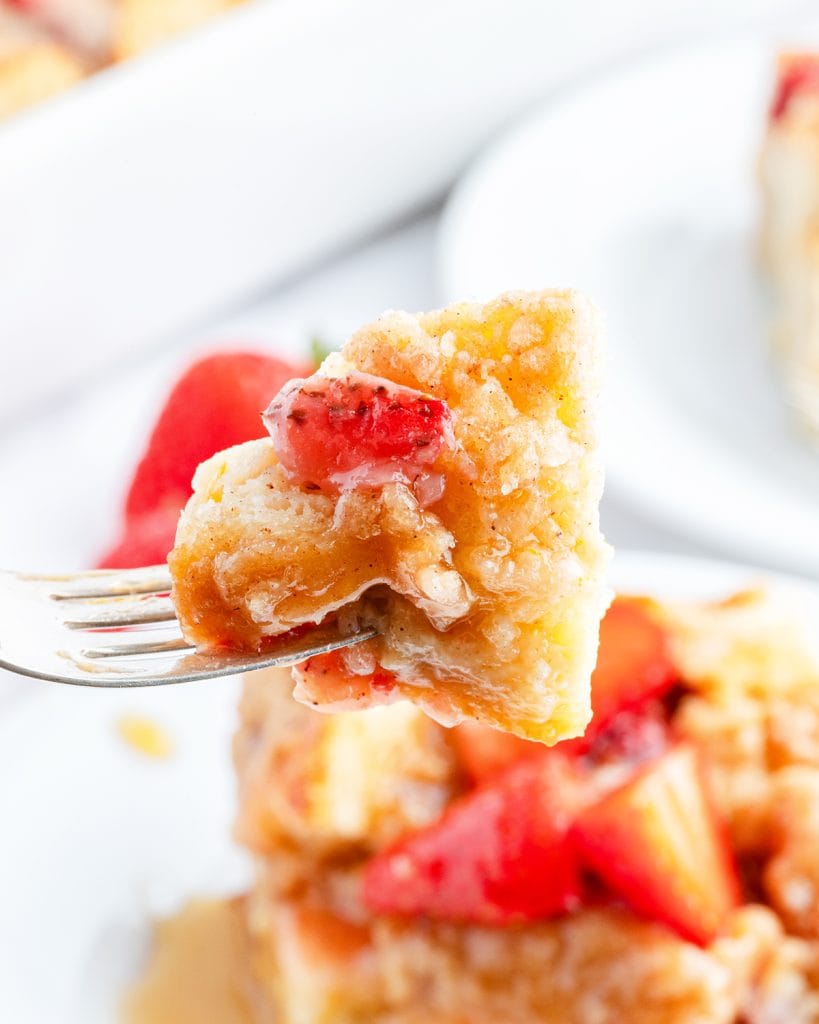 A bite of strawberry French toast Casserole on a fork.
