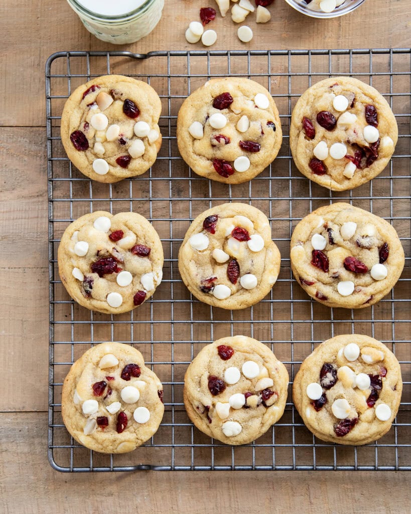 Rows of White Chocolate Macadamia Nut and Cranberry Cookies on a wire cooling rack.