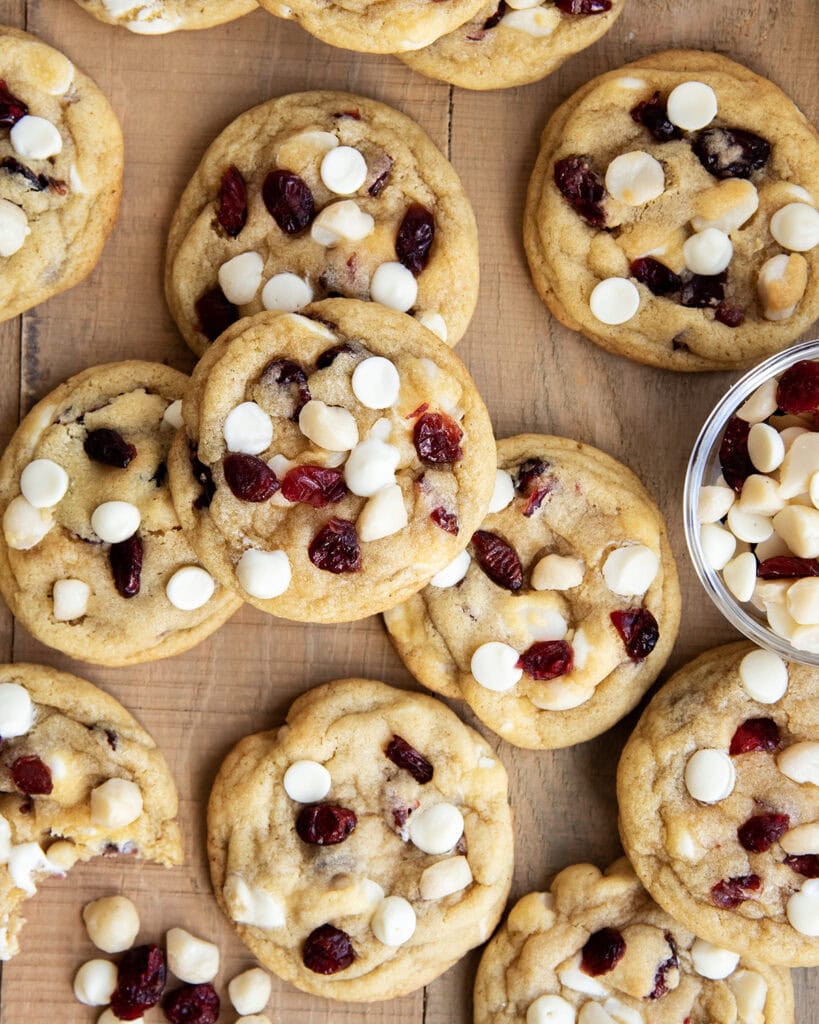 White Chocolate Macadamia Nut and Cranberry Cookies on a wooden table.
