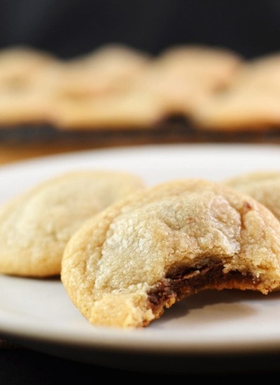 Close up view of peanut butter nutella stuffed cookies on a white plate.