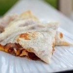 Front view of bbq chicken quesadillas on a metal bakepan.