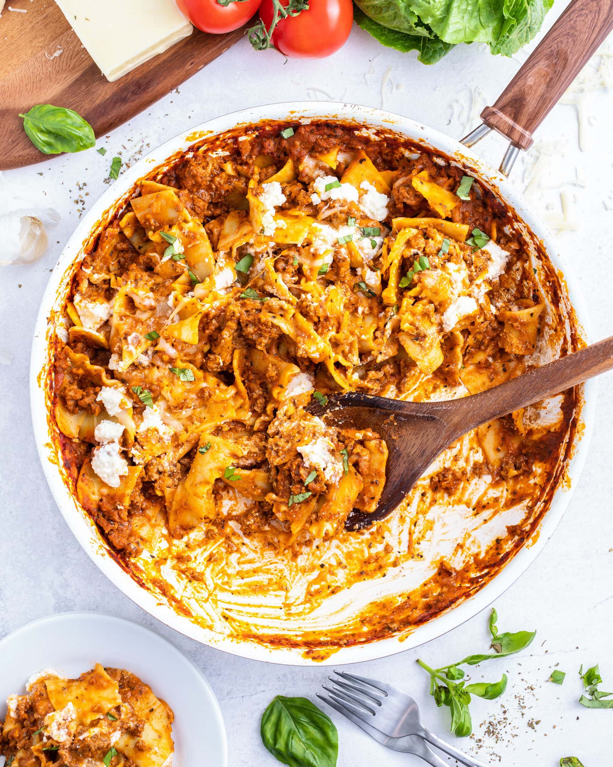 A pan full of skillet lasagna topped with ricotta dollops.
