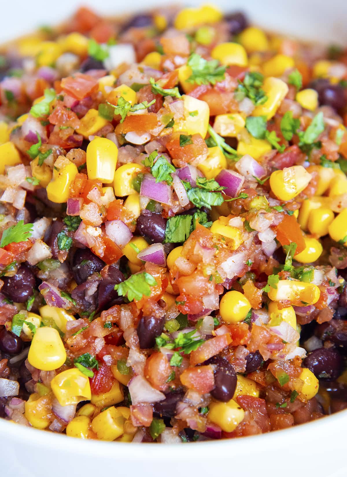 A close up of southwest salsa in a bowl with black beans and corn.
