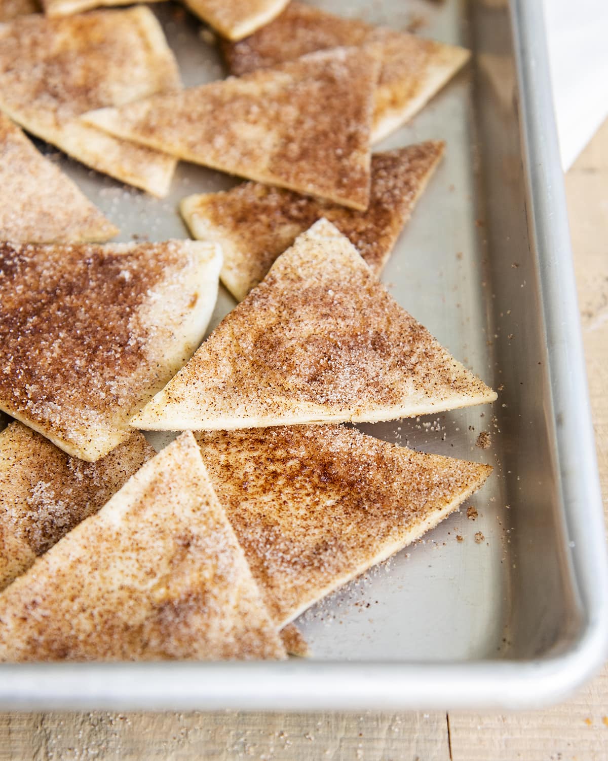 Cinnamon tortilla chips on a pan.