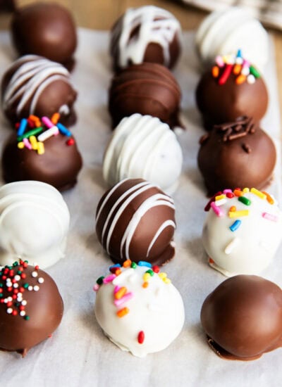 Rows of chocolate covered cookie dough truffles.
