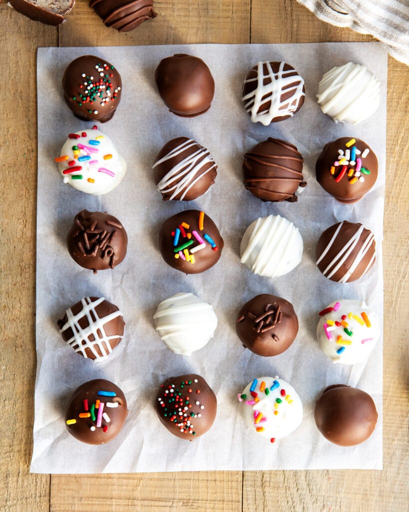An above view of chocolate and white chocolate covered balls or cookie dough.