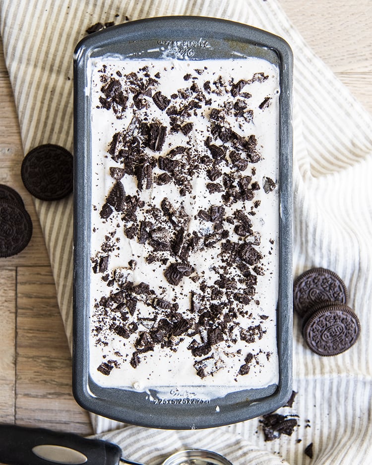 Cookies and cream ice cream with Oreo crumbles on top in a bread loaf pan