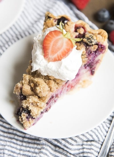 A piece of blueberry and cream pie on a plate.