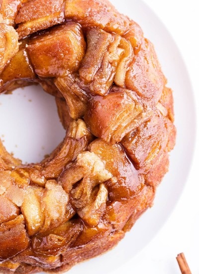 Monkey bread on a white plate, showing the pull apart pieces covered in caramel.
