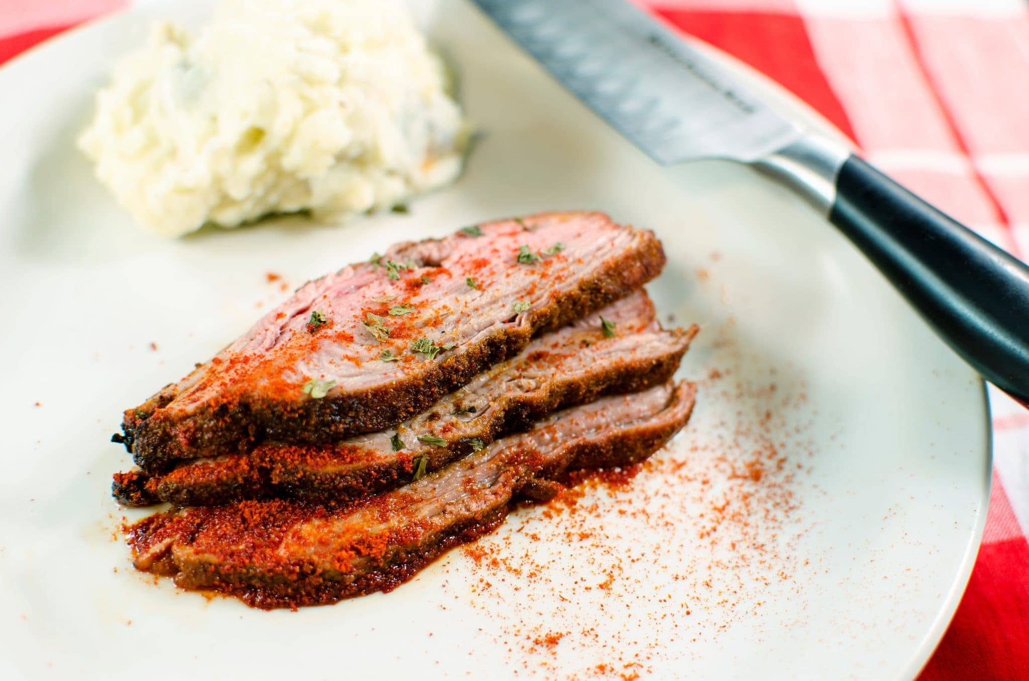 Top view of middle-eastern flank steak on a plate.