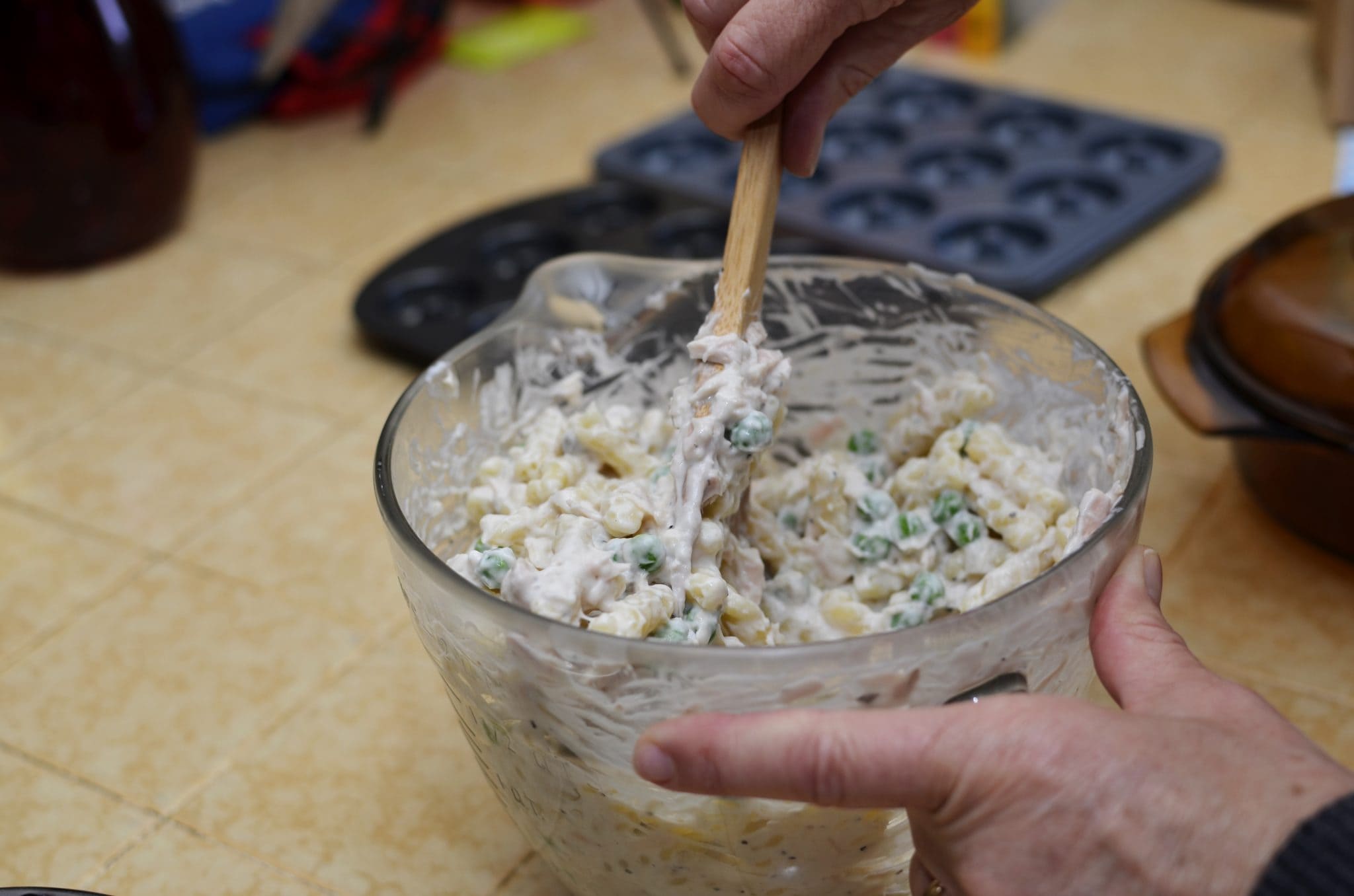 A bowl of tuna casserole being mixed.