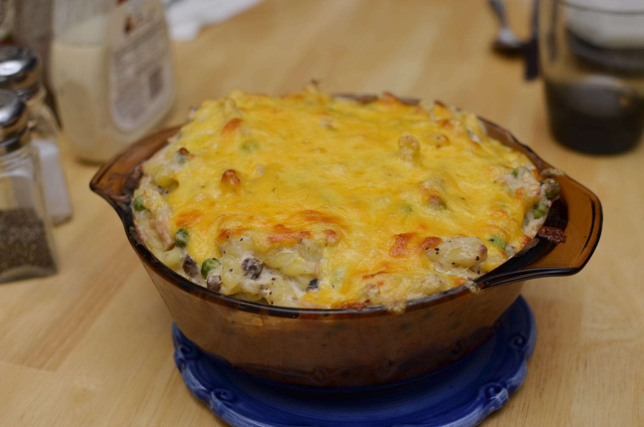 A bowl of tuna casserole cooked with melted cheese on top.
