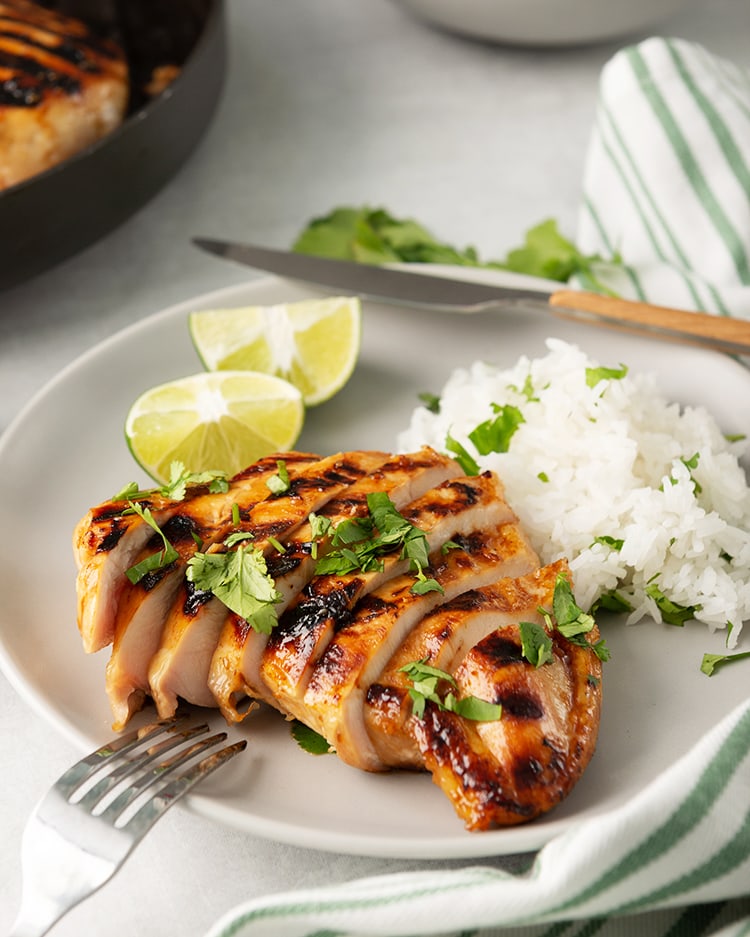 Honey Lime Chicken breast on a plate with cilantro rice