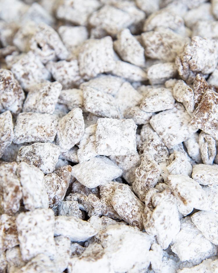 A close up on muddy buddies, which shows the chex cereal coated in chocolate, and powdered sugar.