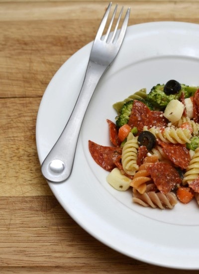 Angled view of pasta salad on a white plate.