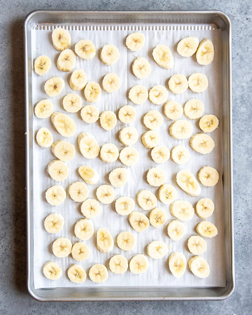 A baking tray covered in banana slices.
