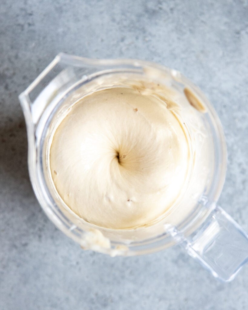 A blender with blended frozen bananas.