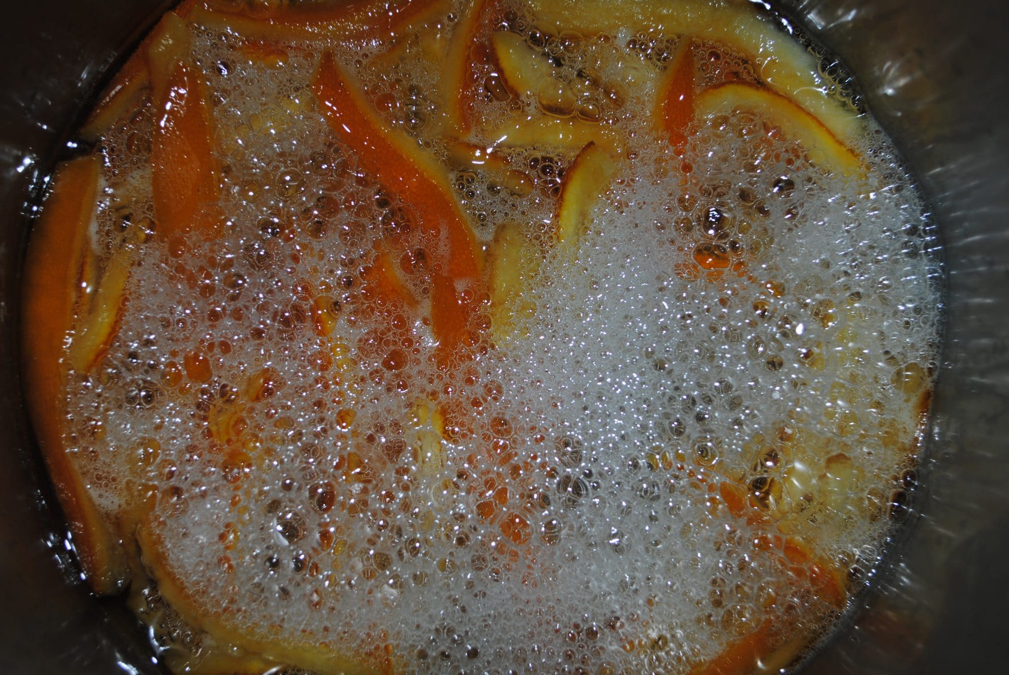 Orange zest slices being fried.