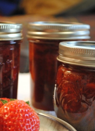 Front view of strawberry balsamic black pepper jam in mason jars.