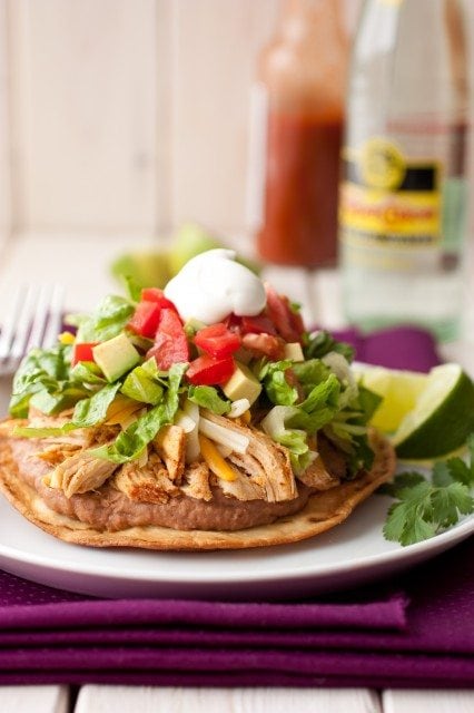 Front view of chicken tostadas on a white plate.