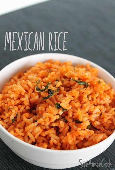 Close up view of mexican rice in a white bowl.
