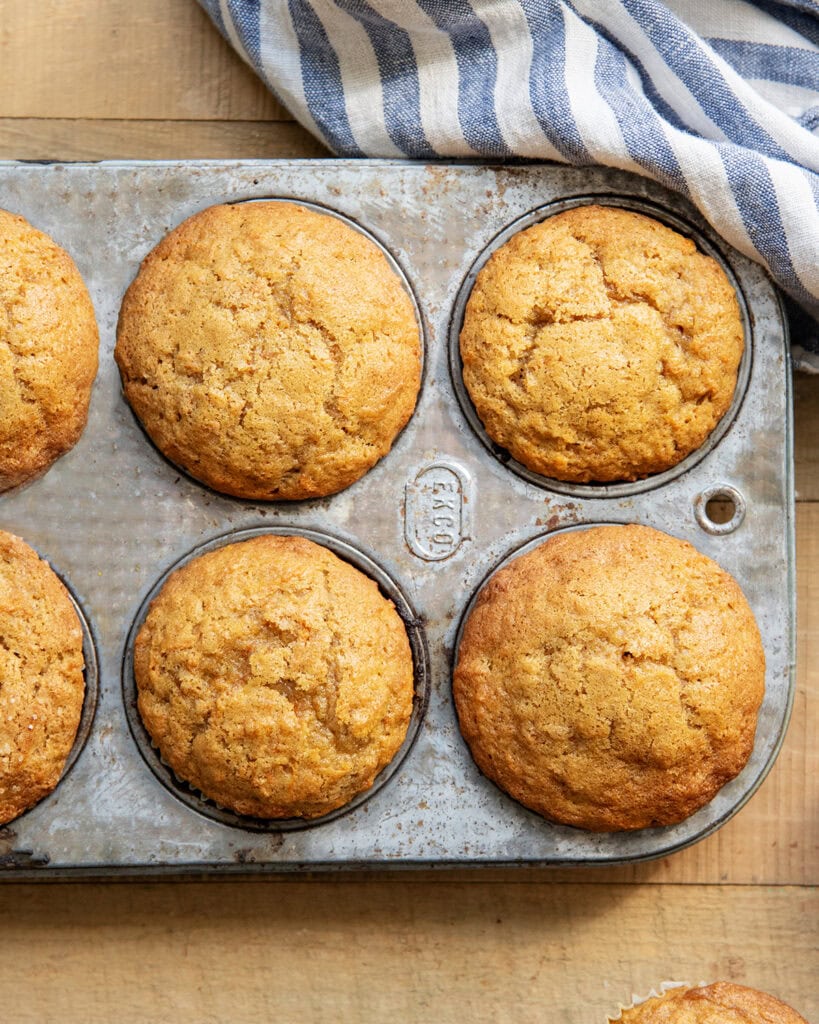An above view of carrot muffins in a muffin pan.