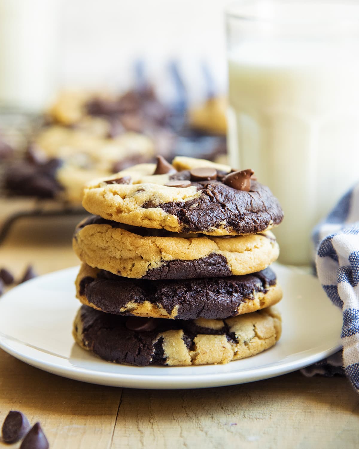 A stack of 4 cookies with peanut butter and chocolate cookie swirled together with chocolate chips.
