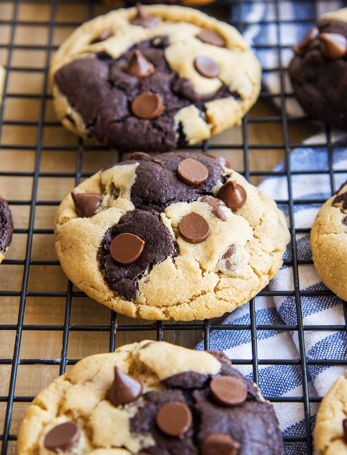 Rows of chocolate and peanut butter swirled cookies on a cooling rack.