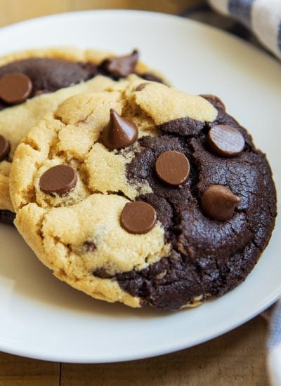 A close up of a chocolate and peanut butter swirled cookie with chocolate chips on top.