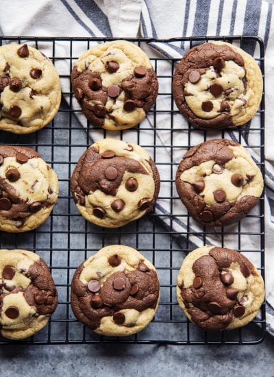 An overhead photo of a cooling rack topped with rows of chocolate chip marble cookies.