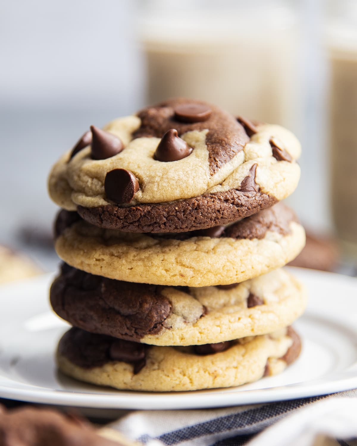 A stack of marble chocolate chip cookies on a plate.