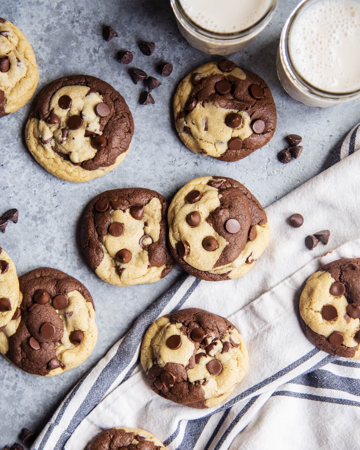 An overhead photo of brookie cookies with two cups of milk.
