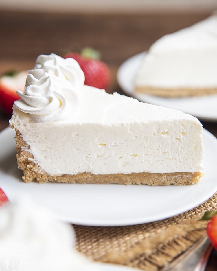 A piece of no bake cheesecake with a graham cracker crust. 