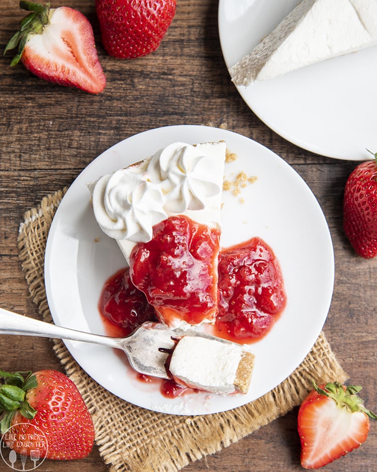 No Bake Cheesecake topped with whipped cream and strawberry sauce